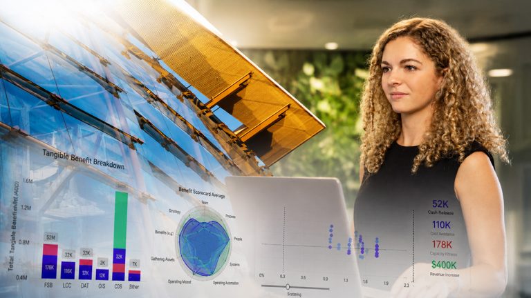 Griffith University data science student working with analytics dashboards beside modern glass campus architecture.