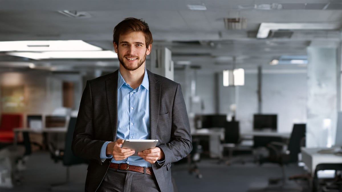 Youthful businessman in large office space