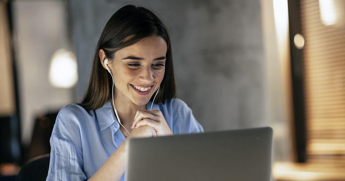 Young woman smiling while using computer