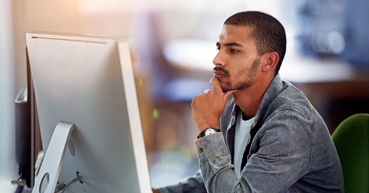 Man looking intently at computer screen