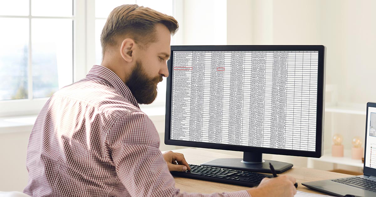 Man with a long workbook list on screen