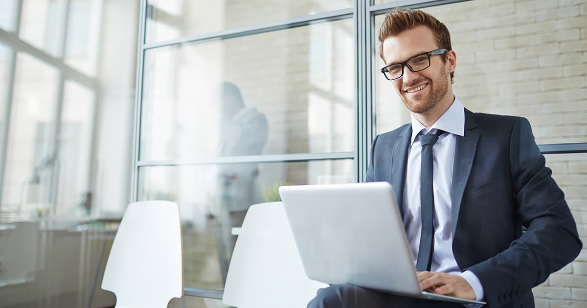 Professional man working on laptop in casual seating environment