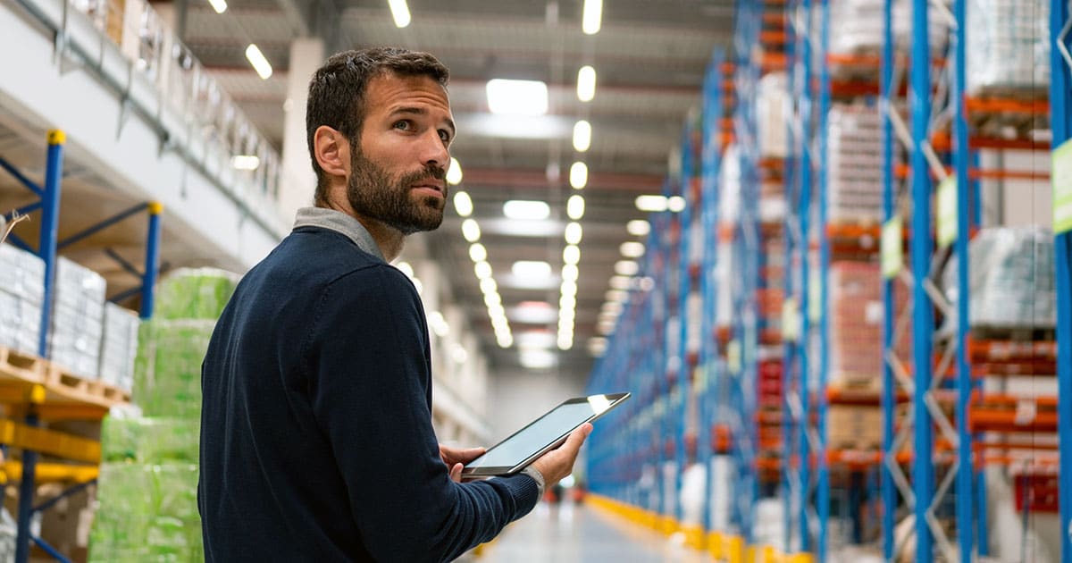 Business professional with computer tablet in warehouse