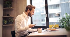 Businessman using laptop and phone