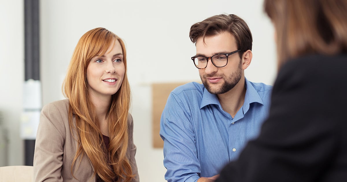 Man and woman consulting with a professional woman