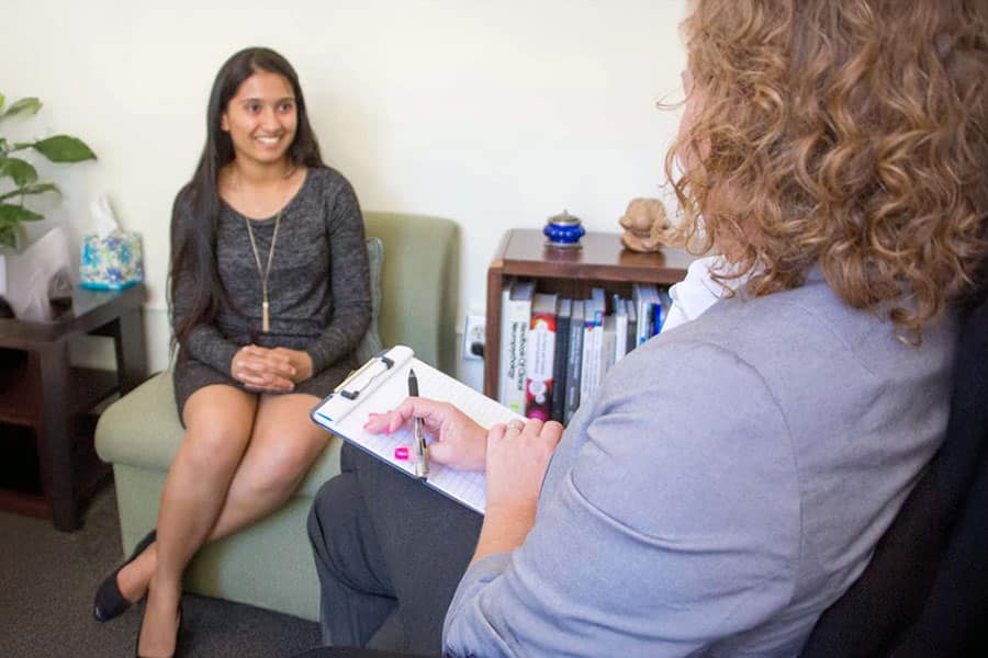 Counsellor with client taking notes