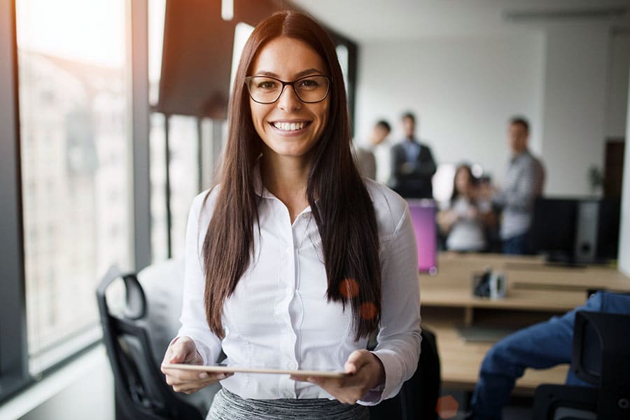 Woman standing in office smiling