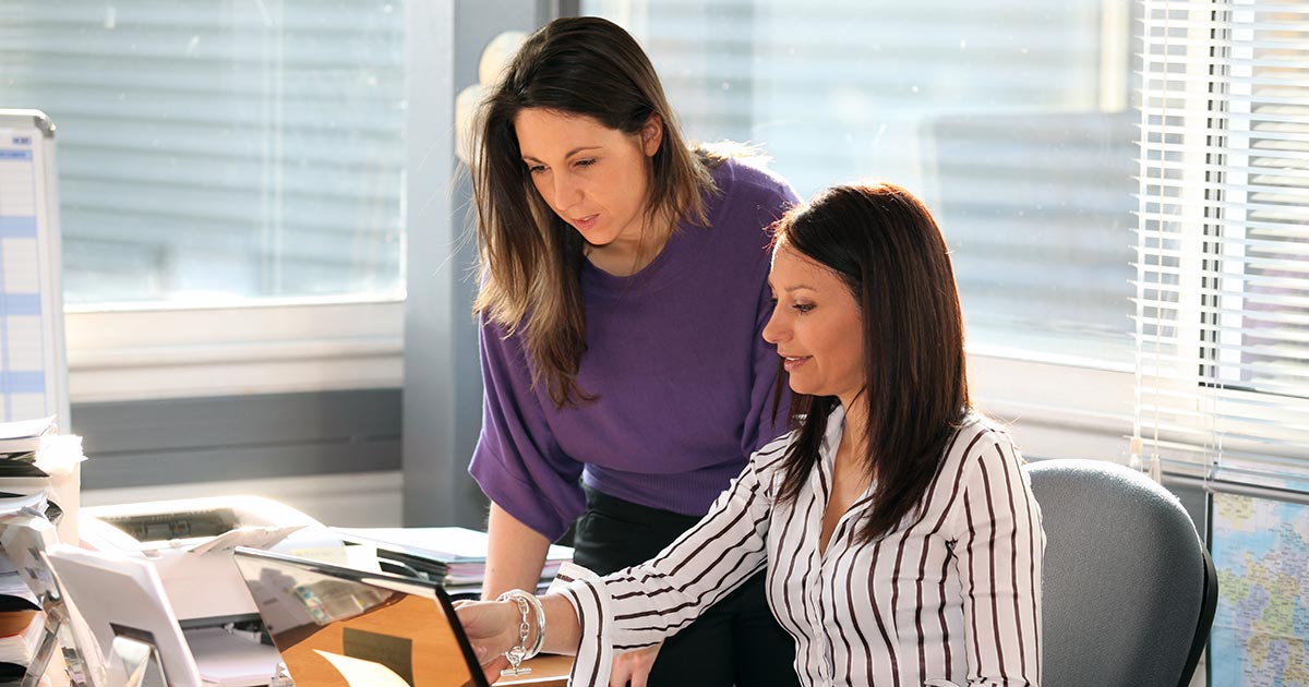 Two female professionals looking over documents