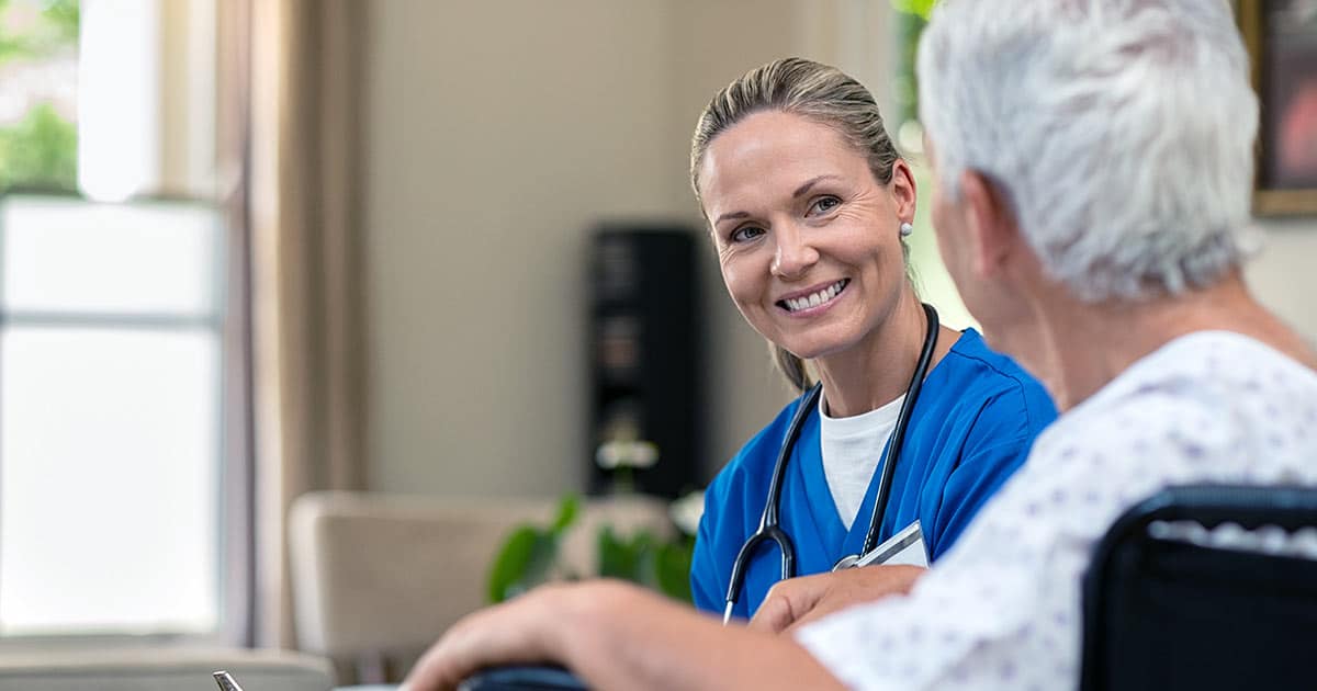 Female medical professional with senior patient in wheelchair