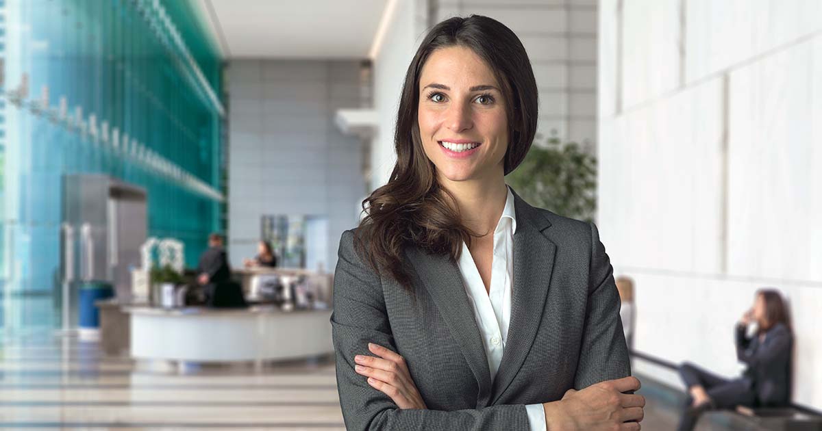 Professional woman in suit with corporate background