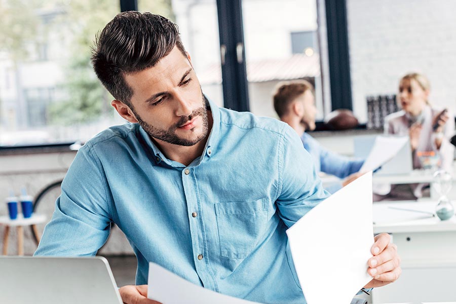 Man glancing at documents at work