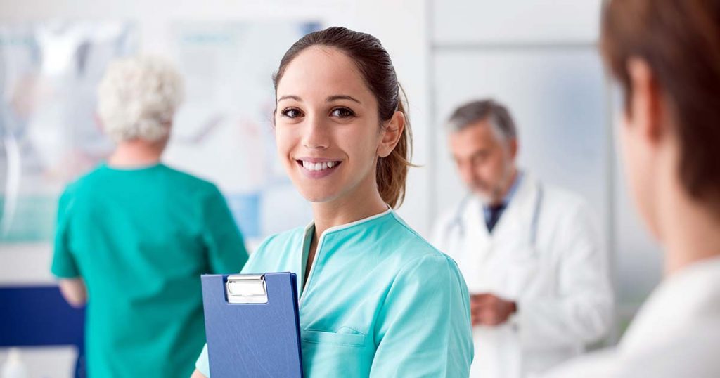 Smiling nurse holding clipboard.