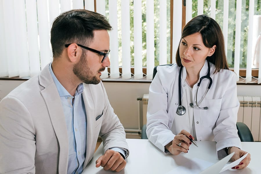 Professional man consulting with female doctor at meeting table