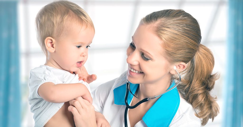 Healthcare professional listening to baby's heart with stethoscope