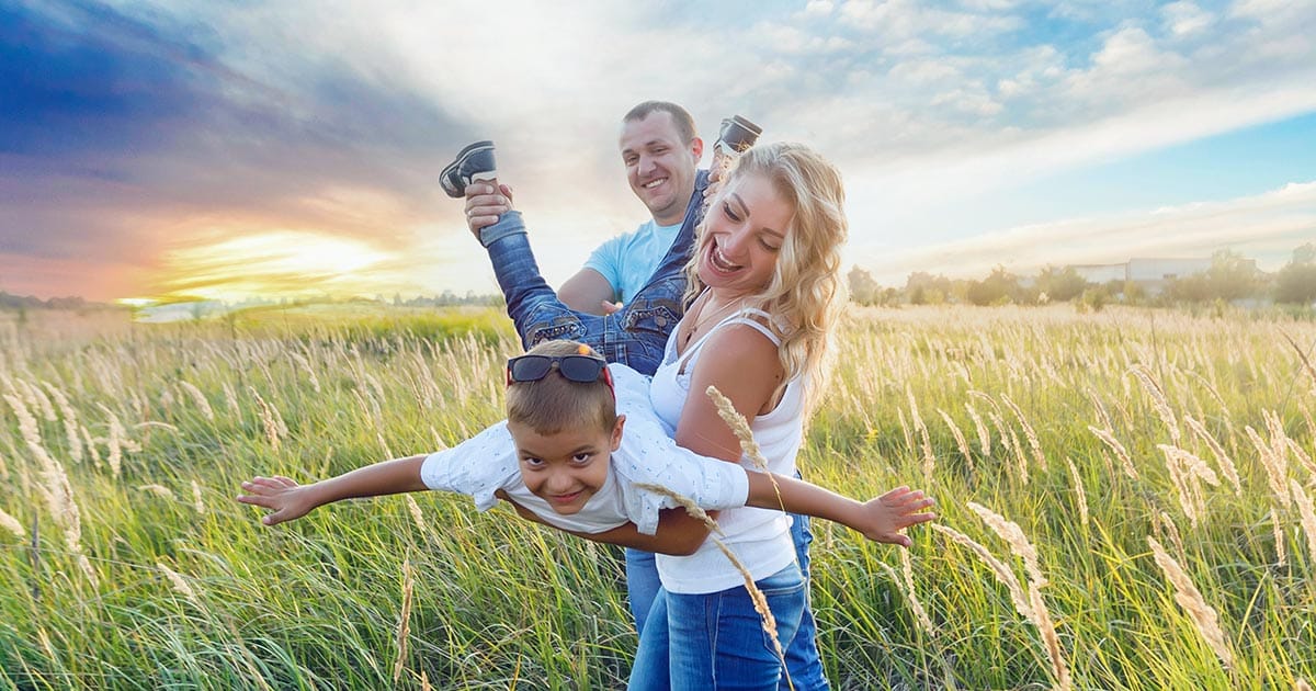 Father, mother and boy in field