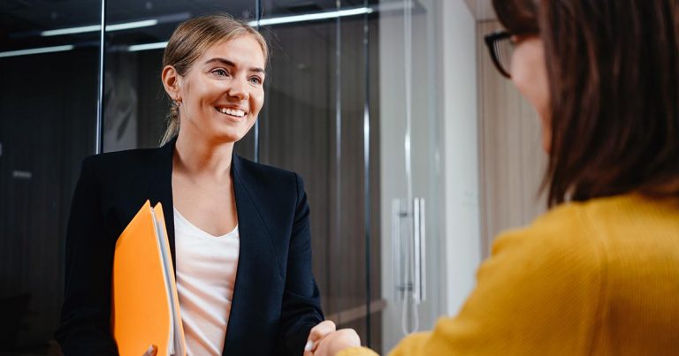 Two professional women shaking hands