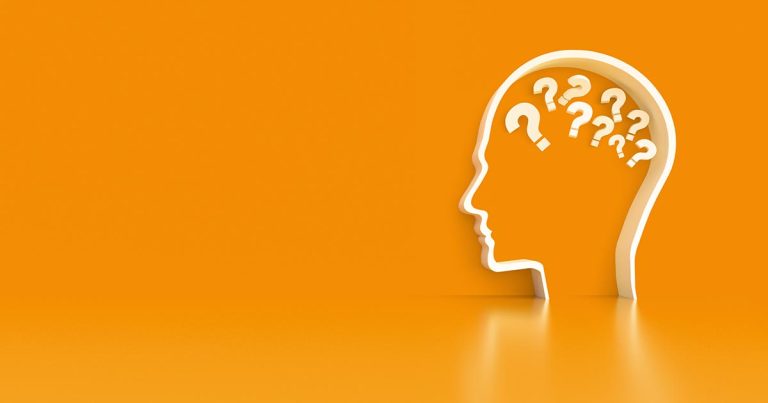 Human psychology illustrated with outline of a head with questions marks in brain section