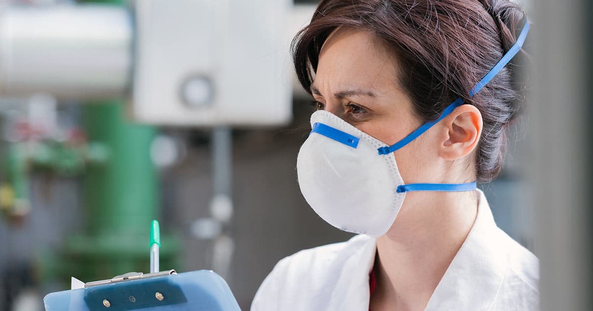 Industrial health inspector wearing mask