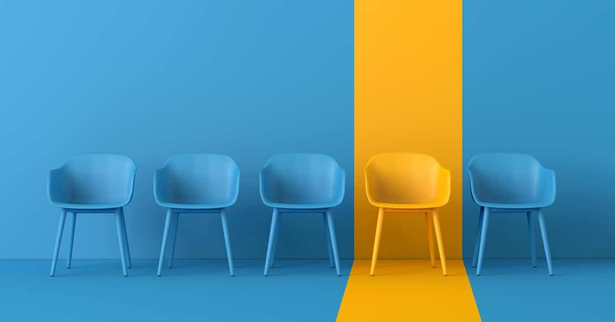 Row of blue chairs with single yellow chair highlighted