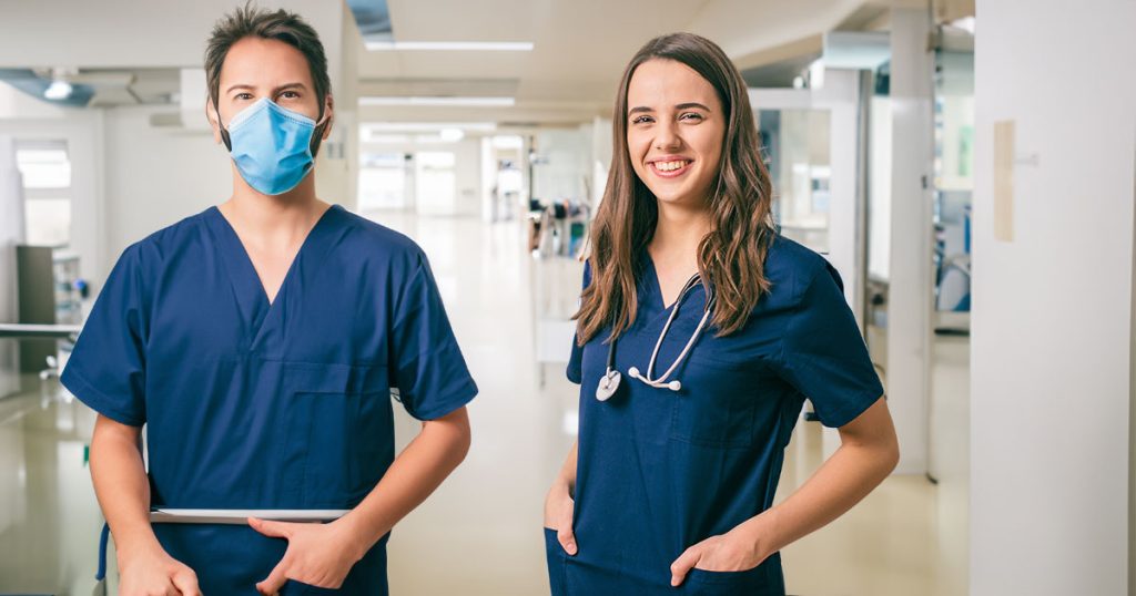 Male and female nurses in a hospital ward