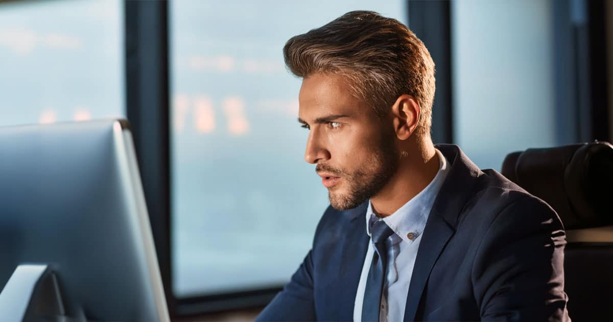 Male professional intensely working at computer