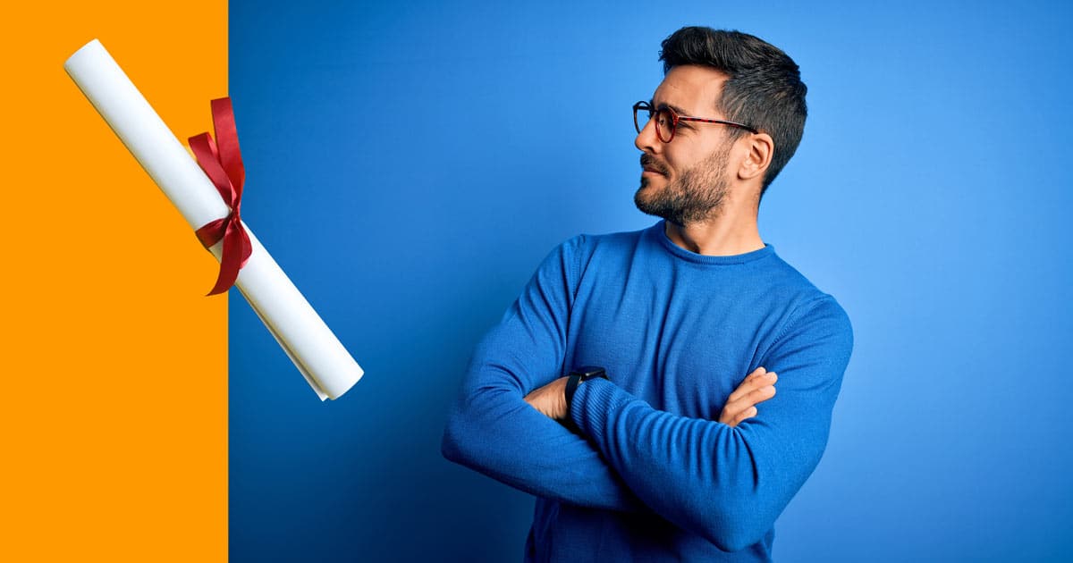 Man eyeing off a university degree literally with arms folded