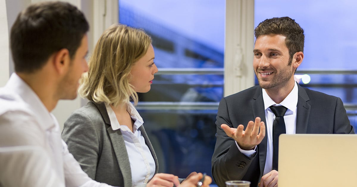 Business colleagues engaged in friendly discussion during a meeting