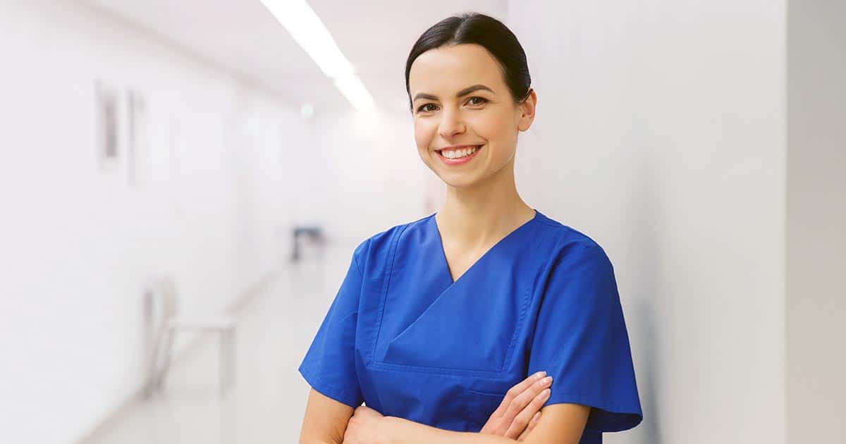Woman in blue scrubs in clinical setting