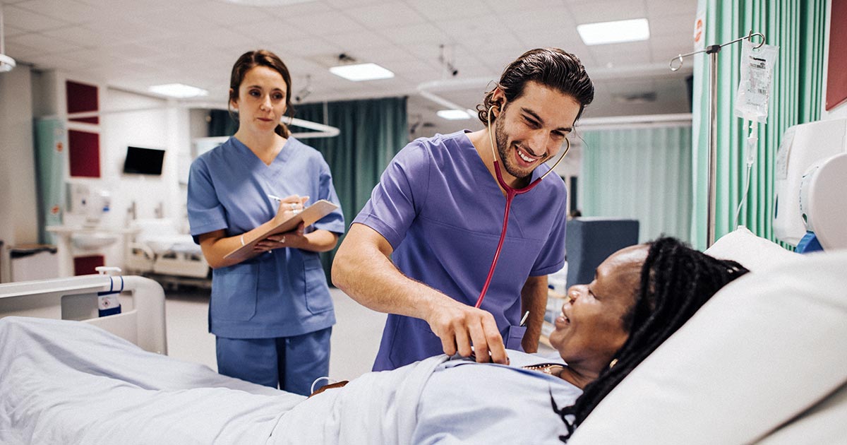 Medical professionals checking heartbeat of hospitalised patient