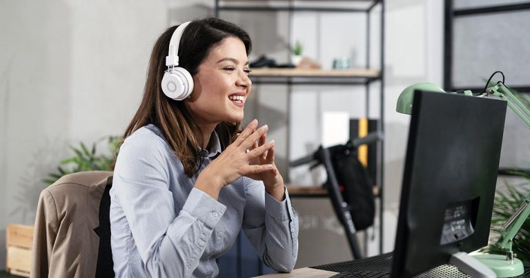 Woman with headphones participating in video call