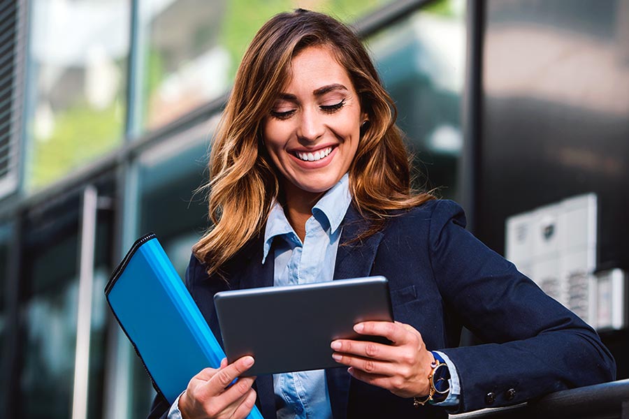 Businesswoman smiling with computer tablet