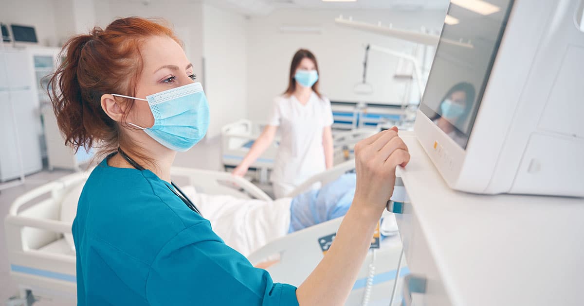 Medical staff monitoring patient vitals in hospital