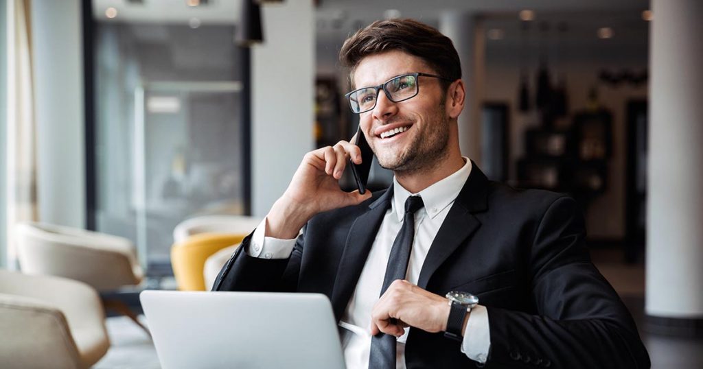 Business professional at computer on phone