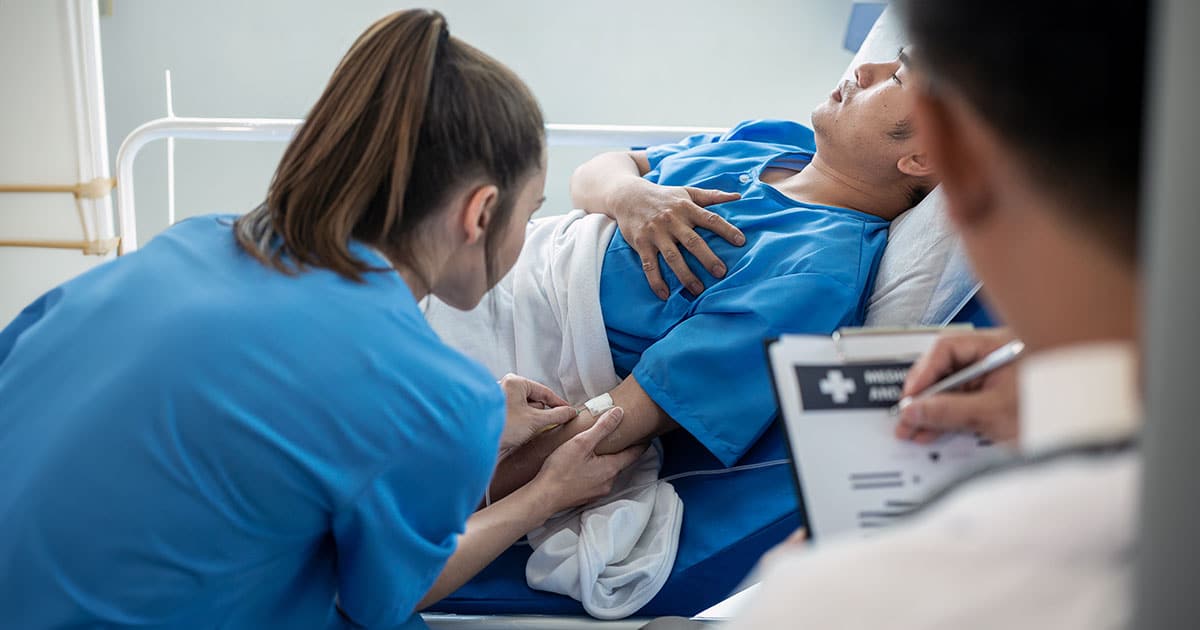 Nurse adjusting catheter in patient arm