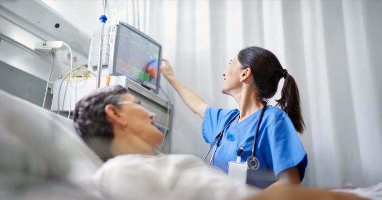 Nurse checking on patient vitals