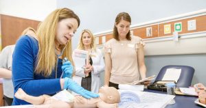 Nurse students practicing on baby doll