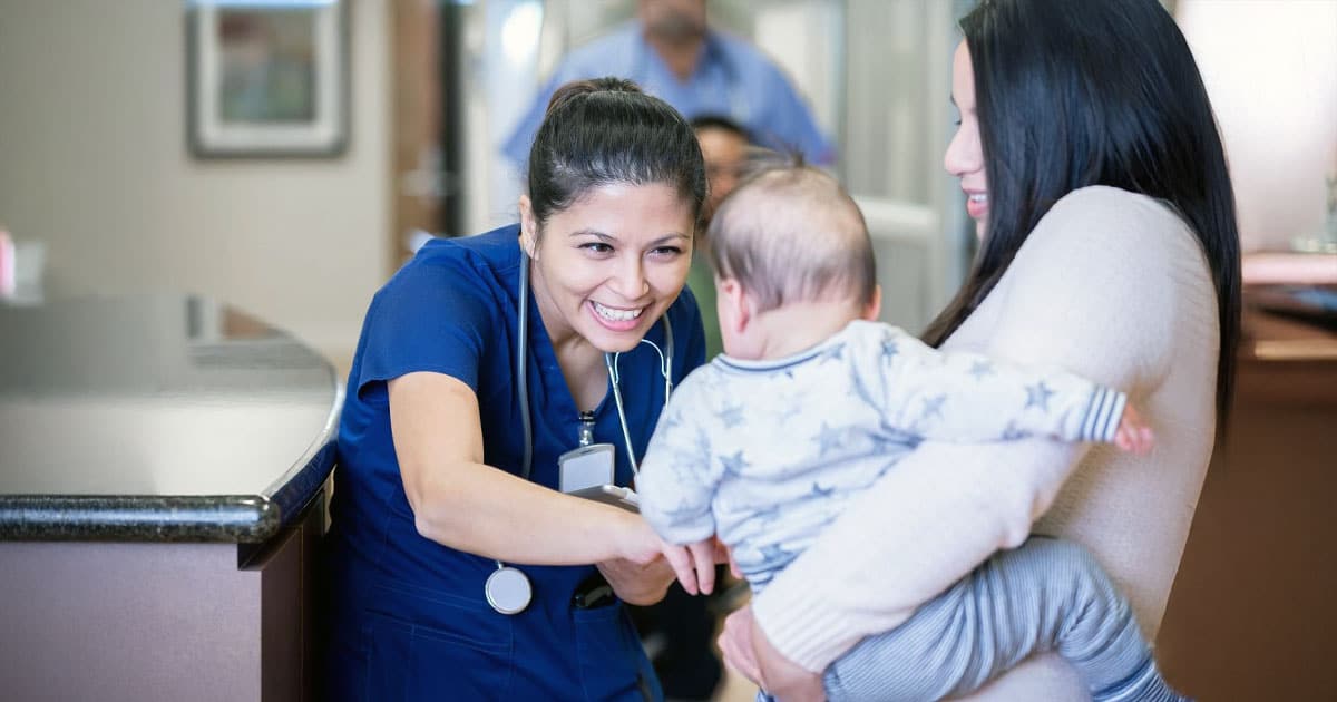 Nurse with mother and baby