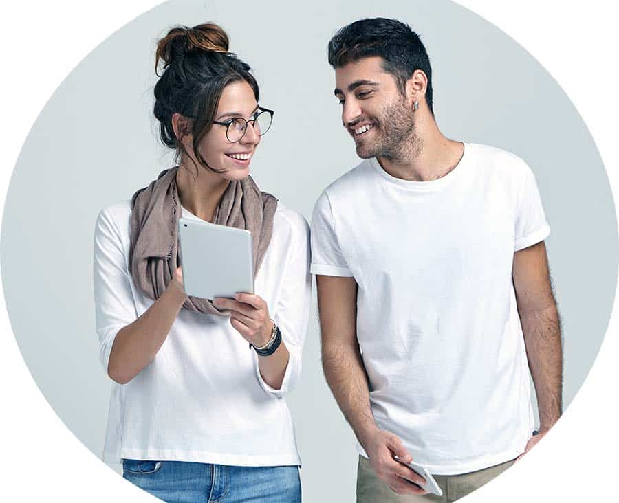 Smiling man and woman looking at computer tablet