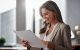 Professional woman smiling while reviewing document