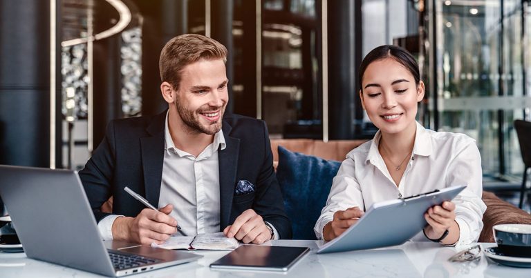 Two business professionals in a friendly work meeting
