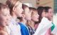 Pupils singing together in choir