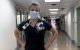 RN wearing mask in hospital corridor