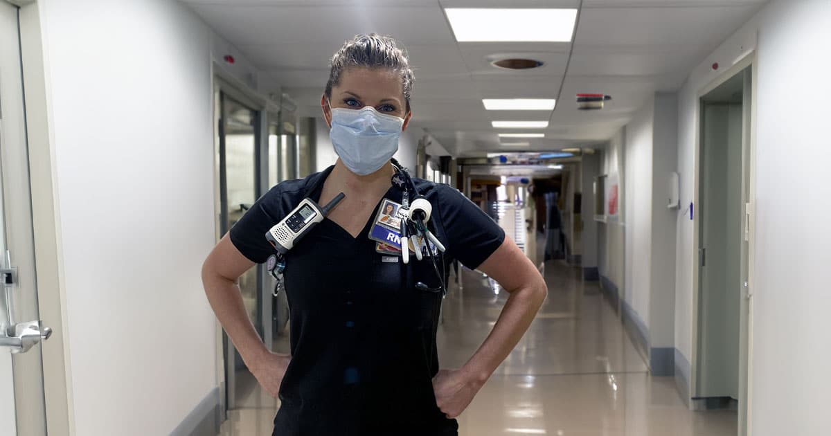 RN wearing mask in hospital corridor