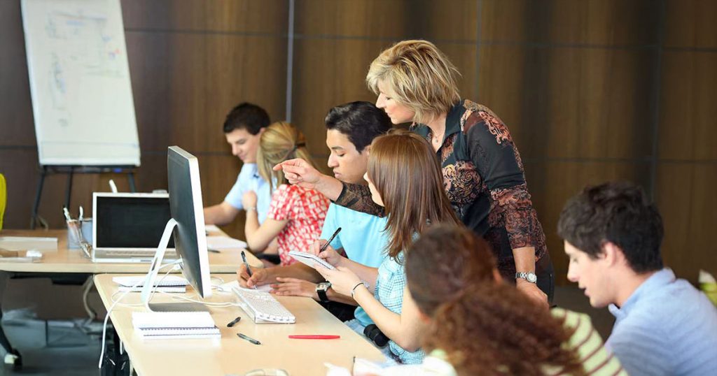 Secondary school teacher helping students