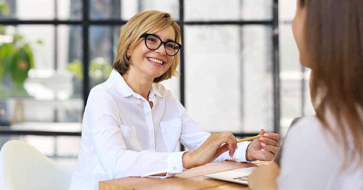 Smiling healthcare professional consulting with young woman