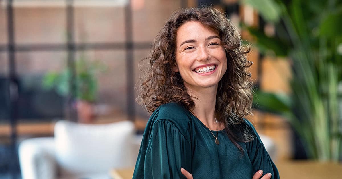 Smiling woman with arms folded