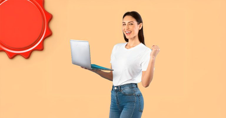 Smiling young woman holding laptop