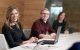 Staff smiling at man in meeting