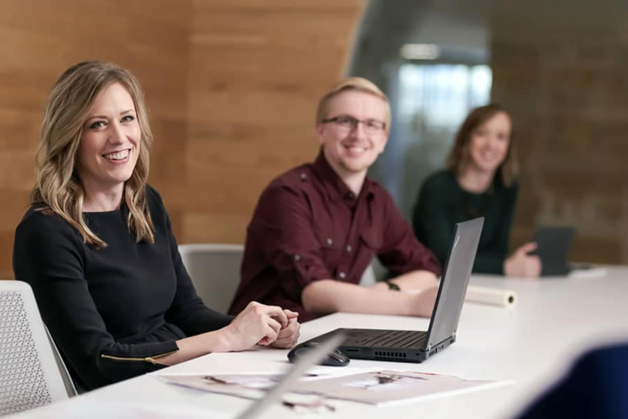 Staff smiling at man in meeting