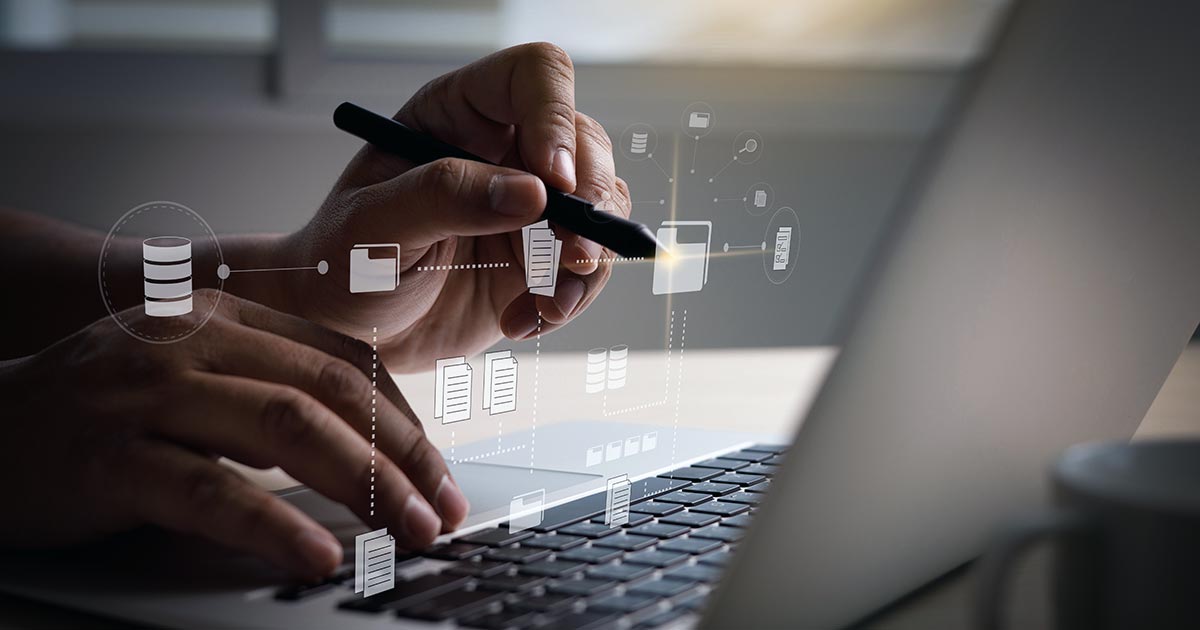 Man using laptop to show connected symbols of documents and data storage